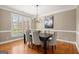 Elegant dining room featuring plantation shutters and a modern chandelier at 411 Hickory Fairway Ct, Woodstock, GA 30188