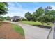 A well-maintained lawn and landscape design are in front of a single-Gathering home at 411 Hickory Fairway Ct, Woodstock, GA 30188