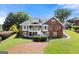 Rear exterior view of home with access to upper-level deck at 411 Hickory Fairway Ct, Woodstock, GA 30188