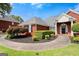 Charming brick home featuring manicured landscaping and a curved walkway at 411 Hickory Fairway Ct, Woodstock, GA 30188