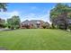 Well-maintained front lawn with mature trees and shrubbery at 411 Hickory Fairway Ct, Woodstock, GA 30188