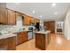 Stylish kitchen with stainless steel appliances, granite countertops, an island, and wooden cabinets at 411 Hickory Fairway Ct, Woodstock, GA 30188