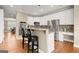Spacious kitchen with a breakfast bar, stainless steel appliances, and white cabinetry at 411 Hickory Fairway Ct, Woodstock, GA 30188