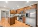 Modern kitchen features stainless steel appliances, granite countertops, and a functional kitchen island at 411 Hickory Fairway Ct, Woodstock, GA 30188
