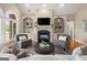 Elegant living room featuring a fireplace, built-in bookshelves, and stylish gray armchairs at 411 Hickory Fairway Ct, Woodstock, GA 30188