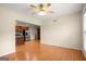 Open-concept living room with hardwood floors leading to a kitchen with stainless steel appliances at 411 Hickory Fairway Ct, Woodstock, GA 30188