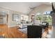 Bright and airy living room with hardwood floors, large windows, and a cozy gray sofa at 411 Hickory Fairway Ct, Woodstock, GA 30188