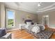 Tranquil main bedroom featuring a trey ceiling, neutral tones, and ample natural light at 411 Hickory Fairway Ct, Woodstock, GA 30188