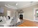 Beautiful primary bedroom featuring a tray ceiling, fireplace, and access to a private balcony at 411 Hickory Fairway Ct, Woodstock, GA 30188