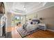 Serene main bedroom suite with trey ceiling, bay windows, and a cozy sitting area at 411 Hickory Fairway Ct, Woodstock, GA 30188