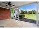Covered patio with ceiling fan and view of expansive green lawn and access to upper deck level at 411 Hickory Fairway Ct, Woodstock, GA 30188