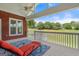 Enclosed patio with brick wall, ceiling fan, and a view of the expansive green lawn at 411 Hickory Fairway Ct, Woodstock, GA 30188