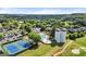 Aerial shot showcasing a community pool, tennis courts, clubhouse and red grain silos, surrounded by lush greenery at 411 Hickory Fairway Ct, Woodstock, GA 30188