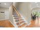 Traditional staircase with hardwood steps and black wrought iron spindles at 411 Hickory Fairway Ct, Woodstock, GA 30188
