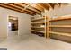 Unfinished basement with exposed ceiling, concrete floors, and wooden shelving at 4924 Locklear Way, Marietta, GA 30066