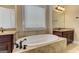 Bathroom featuring a drop-in tub, vanity and tile surround at 4924 Locklear Way, Marietta, GA 30066