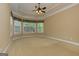 Spacious main bedroom with trey ceilings, carpet flooring, and three large windows at 4924 Locklear Way, Marietta, GA 30066