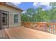 Home back deck showing wood siding, glass door, and railing with trees in the background at 4924 Locklear Way, Marietta, GA 30066