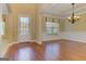 Dining area featuring hardwood floors, a large window, and an elegant chandelier at 4924 Locklear Way, Marietta, GA 30066