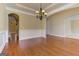 Dining room featuring hardwood floors, wainscoting, modern chandelier, and archway to another room at 4924 Locklear Way, Marietta, GA 30066