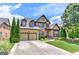 Beautiful two-story brick home featuring a two-car garage, lush landscaping, and a welcoming front entrance at 4924 Locklear Way, Marietta, GA 30066