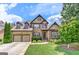 Beautiful two-story brick home featuring a two-car garage, lush landscaping, and a welcoming front entrance at 4924 Locklear Way, Marietta, GA 30066