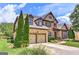 Beautiful two-story brick home featuring a two-car garage, lush landscaping, and a welcoming front entrance at 4924 Locklear Way, Marietta, GA 30066