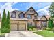 Beautiful two-story brick home featuring a two-car garage, lush landscaping, and a welcoming front entrance at 4924 Locklear Way, Marietta, GA 30066