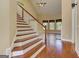 Foyer featuring wood stairs, hardwood floors, and views to the living room and second floor at 4924 Locklear Way, Marietta, GA 30066