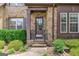 Covered entryway showcasing the front door of this brick home with dark accents at 4924 Locklear Way, Marietta, GA 30066