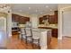 Kitchen with granite countertops, stainless steel appliances, and dark wood cabinets and island with seating at 4924 Locklear Way, Marietta, GA 30066