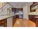 Kitchen with stainless steel appliances, granite countertops, dark wood cabinets, and a breakfast bar at 4924 Locklear Way, Marietta, GA 30066