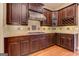 Kitchen with stainless steel appliances, dark wood cabinets, granite countertops, and a wine rack at 4924 Locklear Way, Marietta, GA 30066