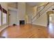 Spacious living room featuring a fireplace, hardwood floors, and a staircase to the second floor at 4924 Locklear Way, Marietta, GA 30066