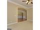 Living room with neutral carpet and an arched entry looking towards the dining area at 4924 Locklear Way, Marietta, GA 30066