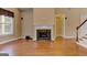 Open living room featuring hardwood floors, fireplace, lots of natural light, and stairs to the second floor at 4924 Locklear Way, Marietta, GA 30066