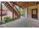 View of the covered patio featuring a wooden staircase leading to the backyard and a door to a potential basement at 4924 Locklear Way, Marietta, GA 30066
