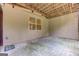 Covered outdoor patio area with a planked ceiling, gray siding, concrete floor, and a window view of the backyard at 4924 Locklear Way, Marietta, GA 30066