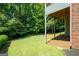 Large backyard with trees and partial shade underneath a deck, providing ample space for outdoor activities at 5418 Amity Dr, Powder Springs, GA 30127