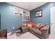 Basement living area featuring cozy seating, built-in shelves, and warm accents at 5418 Amity Dr, Powder Springs, GA 30127