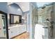 Well-appointed bathroom with double vanity, large mirror, and a glass-enclosed shower at 5418 Amity Dr, Powder Springs, GA 30127