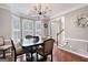 Dining room featuring hardwood floors, a modern chandelier, and a bay window, providing ample natural light and style at 5418 Amity Dr, Powder Springs, GA 30127