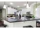 An open kitchen view boasts white cabinets, granite counters, and stainless steel appliances at 5418 Amity Dr, Powder Springs, GA 30127