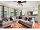 Open-concept living room with a spacious sectional sofa, hardwood floors, and an adjacent kitchen, ideal for modern living at 5418 Amity Dr, Powder Springs, GA 30127
