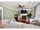 Comfortable living room featuring a brick fireplace, hardwood floors, and a plush sectional sofa, creating a warm and inviting ambiance at 5418 Amity Dr, Powder Springs, GA 30127