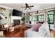 Spacious living room with a brick fireplace, hardwood floors, and a large sectional sofa, perfect for relaxation and gatherings at 5418 Amity Dr, Powder Springs, GA 30127