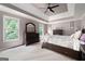 Spacious main bedroom with a tray ceiling, large windows, and dark wood furniture at 5418 Amity Dr, Powder Springs, GA 30127