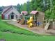 Community playground with slides, climbing structures, and a recreational building at 5418 Amity Dr, Powder Springs, GA 30127