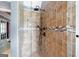 Tiled shower with rain shower head, handheld sprayer, and built-in niche at 5418 Amity Dr, Powder Springs, GA 30127