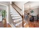 Elegant staircase with wooden steps and white railings, leading to the upper level with hardwood floors throughout at 5418 Amity Dr, Powder Springs, GA 30127